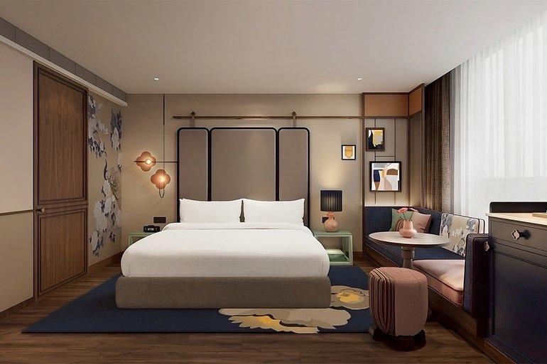 Image depicts a rendering of the rooms at the upcoming voco Phuket. The image is a modern design with aspects of nature such as flowers on the walls and furniture.