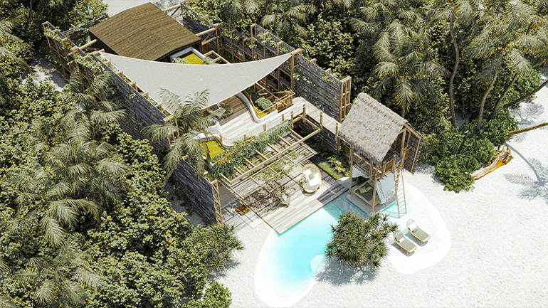Image is a resort rendering of Vaagali Maldives, Vignette Collection. The image depicts a cabin style villa which is nestled into a forest next to the beach. 