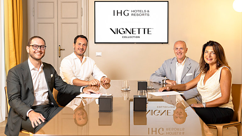 A signing ceremony photo of Fabrizio Piolanti (Development Director, IHG Hotels & Resorts), Guillermo Pérez Palacios (CEO, Panoram Hotel Management), Nadia Perna (Blu Lava Resorts, Owner), and Fabrizio Trimarchi (Development Director, Panoram Hotel Management) sitting around a table