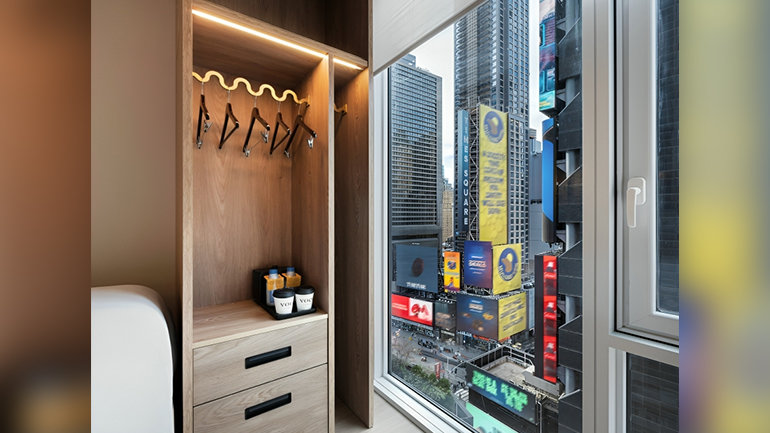 Guest room views from voco Times Square – Broadway, featuring scenes below of New York’s iconic district