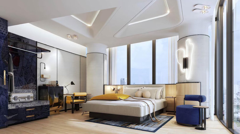 Contemporary hotel room featuring a king bed, workspace and city views.