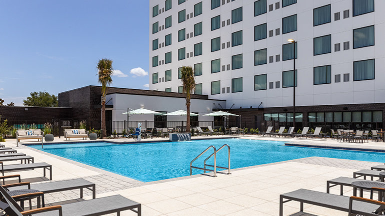 Expansive resort-style outdoor pool at EVEN Hotel Orlando Universal Blvd by IHG and Staybridge Suites Orlando Universal Blvd by IHG