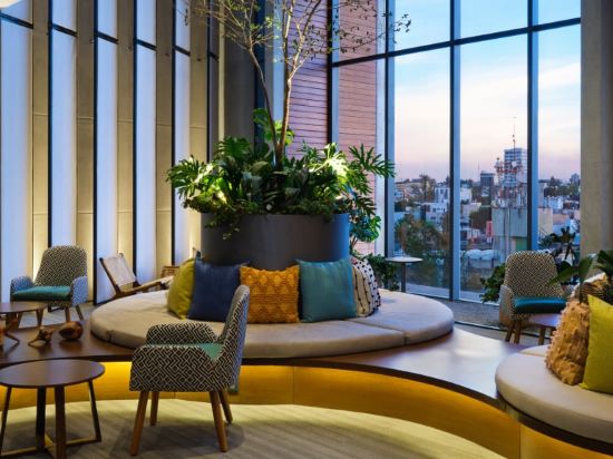 Comfortable seating arrangement with vibrant cushions in a Voco hotel lounge